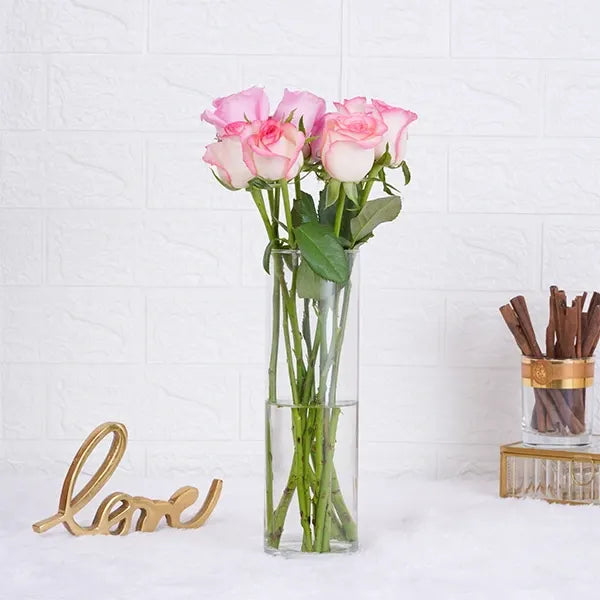 10 jumeila roses in long glass jar front view