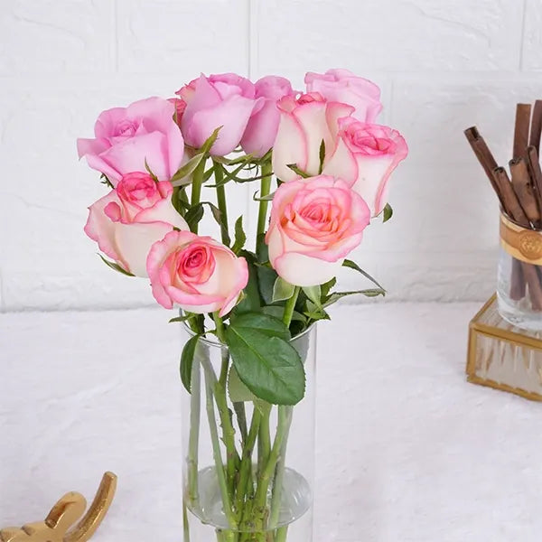10 jumeila roses in long glass jar top up view
