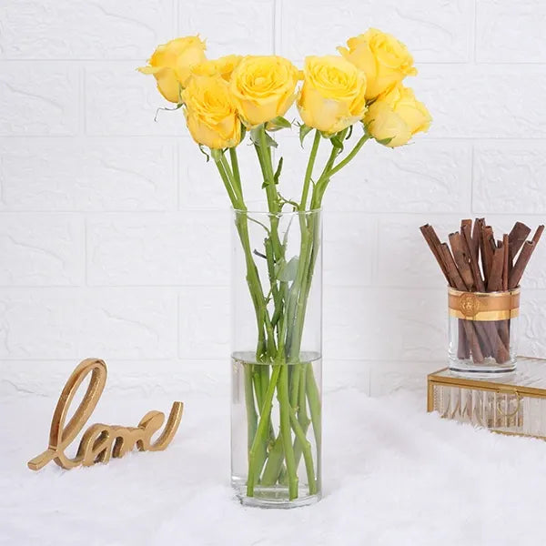 10 yellow roses in long glass jar front view