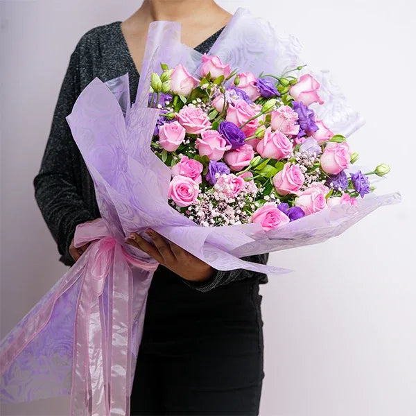 30 pink roses bouquet with purple eustoma close up view