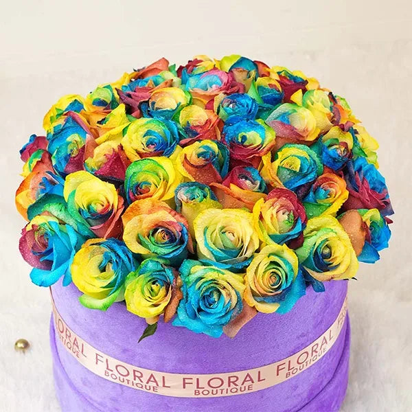 rainbow roses in purple box arrangement top view