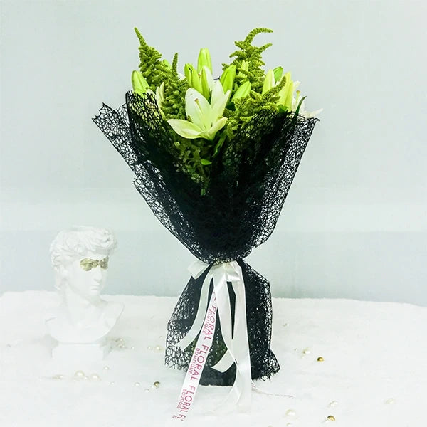 asclepias and green amaranth with kamini leaves in black net wrap front view