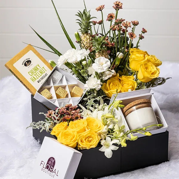 yellow roses white carnations flower with hazelnut chocolate in black box top view