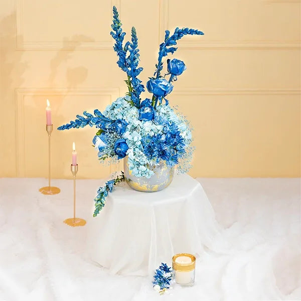 blue hydrangeas and snapdragons in a grey pot front view