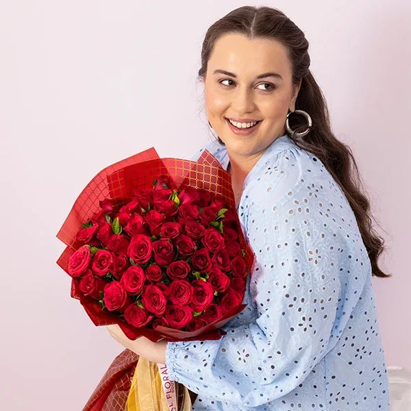bouquet of 50 red roses? wrapped in red and gold paper top view