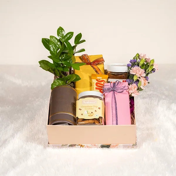 curated hamper with artisanal chocolates and aromatic candles front view