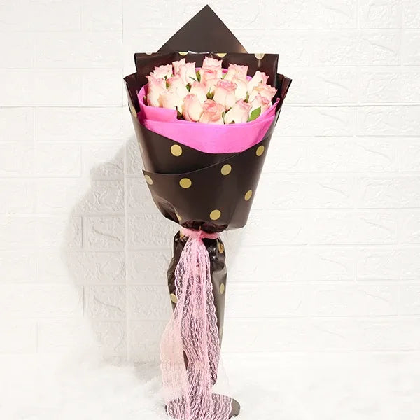 elegant jumilia pink rose bouquet in pink and black wrap front view