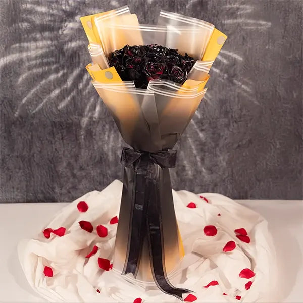 20 black rose bouquet wrapped in yellow-dotted black and white paper front view