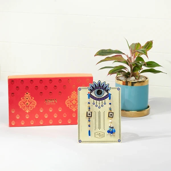 evil eye rakhi lumba hamper with asha sweet mix aglaonema in blue pot front view