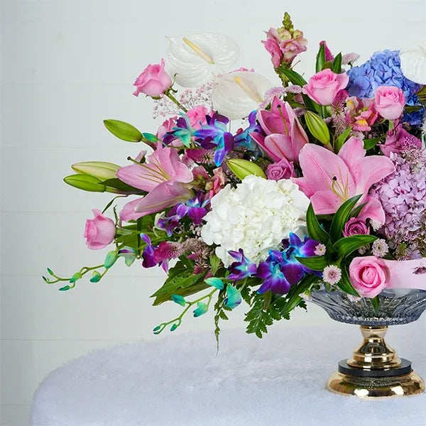 glass vase white anthuriums hydrangeas oriental lilies six blue orchids five pink button chrysanthemums close up view