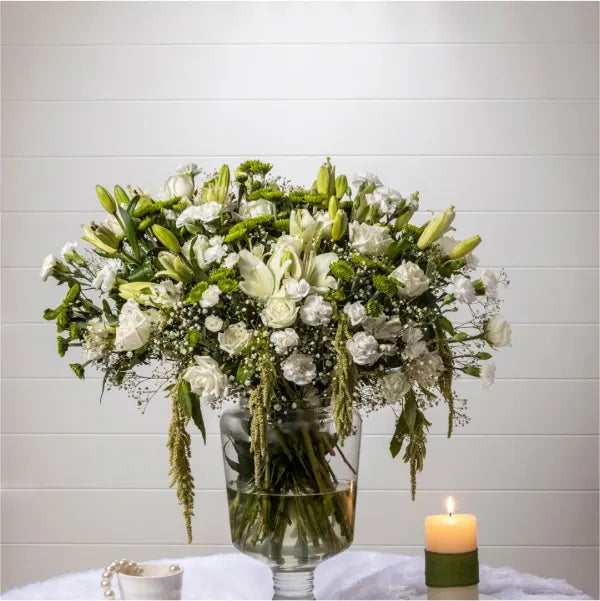 white rose asiatic lily white green button chrysanthemum in a glass vase front view