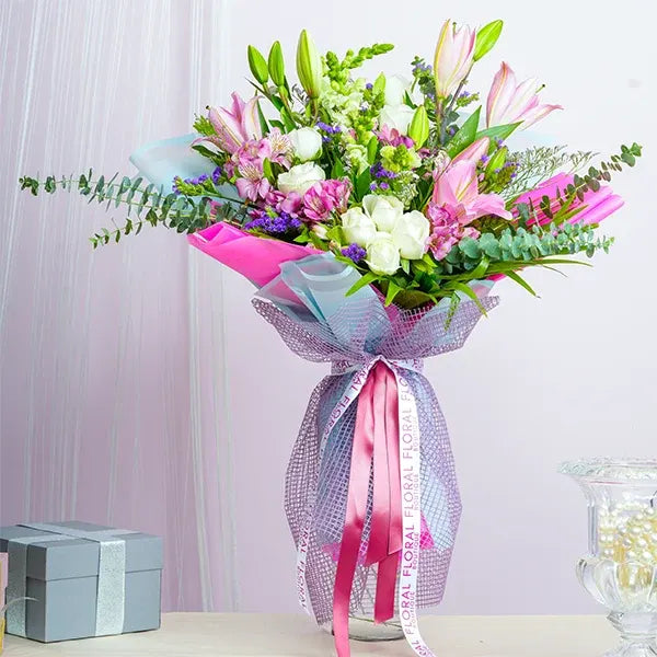 mix flower bouquet of pink oriental lilies with white flowers front view
