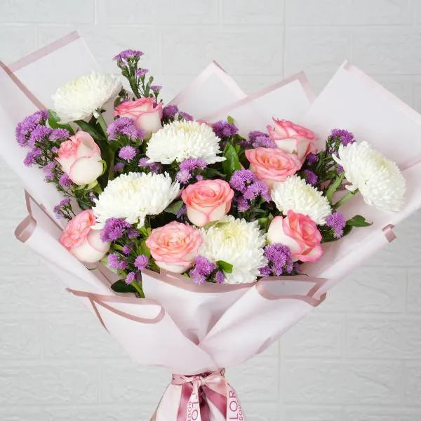 mixed flower bouquet of pink roses white disbuds top view