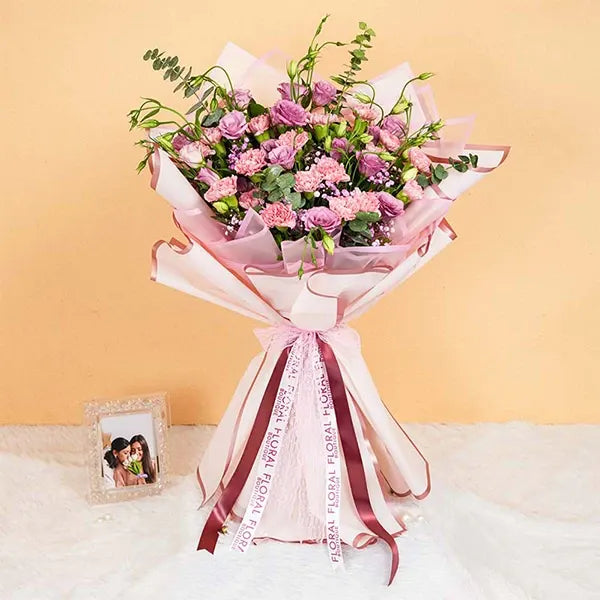 mixed bouquet wrapped in pink for mothers day front view