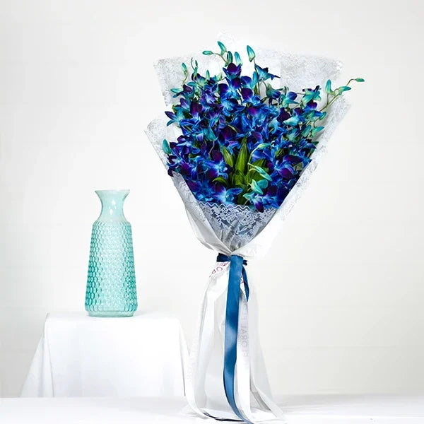 orchid bouquet with white wrapping and ribbon featuring with jamaica front view