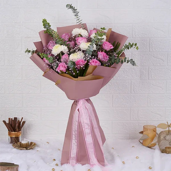 pink and white bouquet of pink roses wrapped in pale pink paper front view