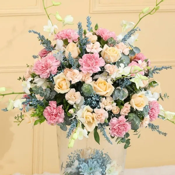 pink carnation and peach rose in glass vase closeup view