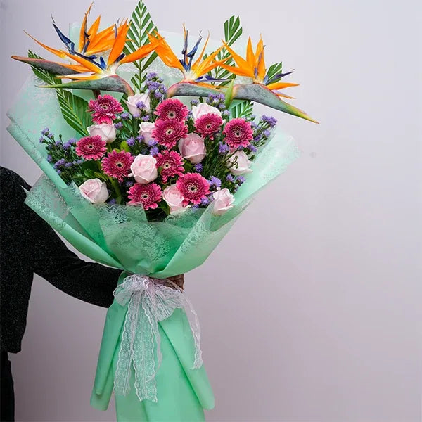 pink flower bouquet with a mix of roses gerberas and daisies front view