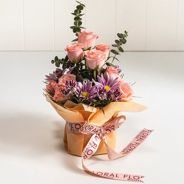 baby pink roses with chrysanthemums in a square glass vase front view
