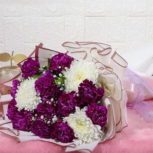 purple carnations bouquet with disbuds and gypsophila close up view