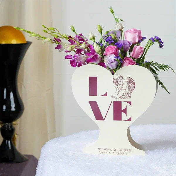 revival roses purple orchids in a white heart shaped box front view