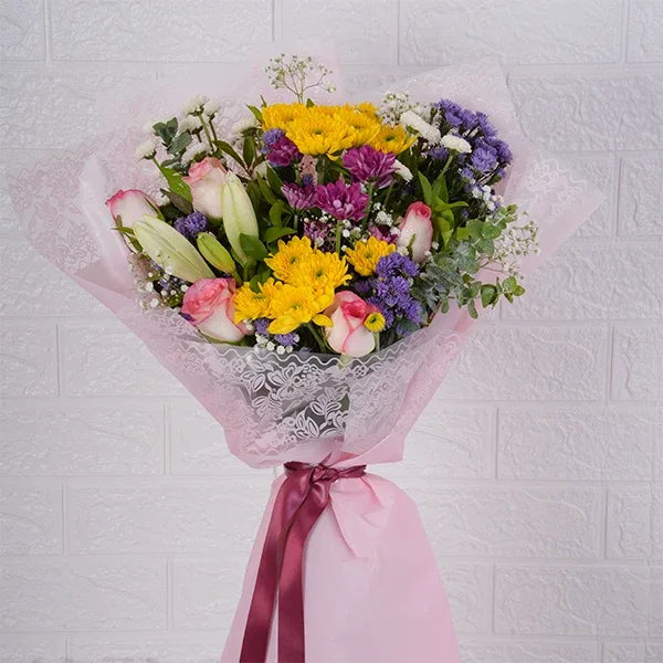 mix flower bouquet with roses and daisy closeup view