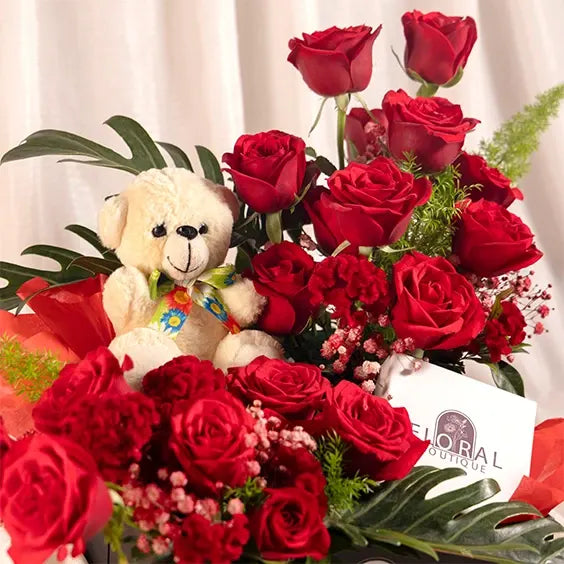 flower box arrangement of red roses celosia red with xanadu closeup view