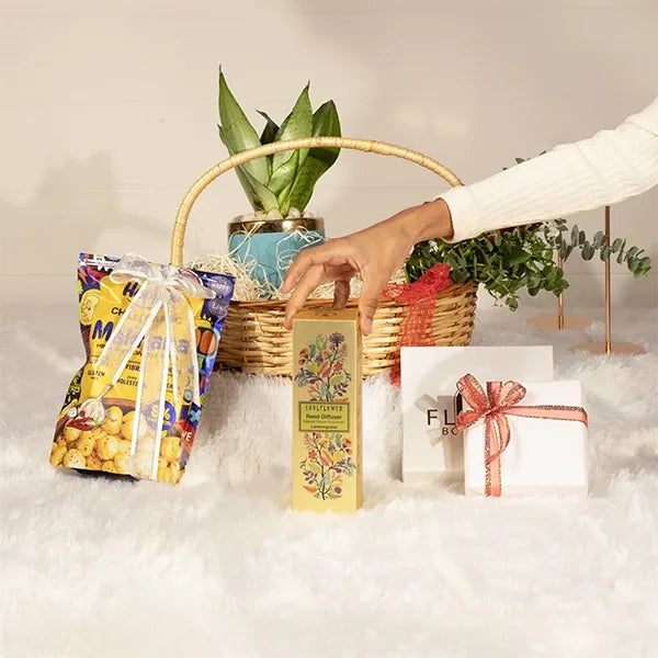 woven basket hamper with fresh flowers chocolates and assorted snacks front view 3