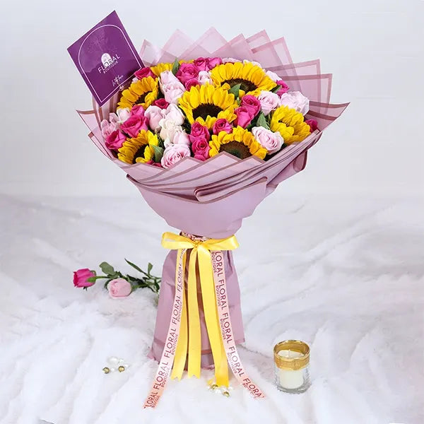 sunflower and pink rose bouquet with purple wrap front view 2