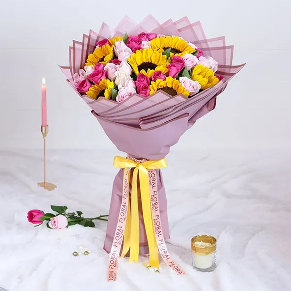 sunflower and pink rose bouquet with purple wrap front view