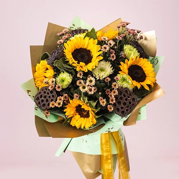 sunflower bouquet with disbuds and dry lotus top view