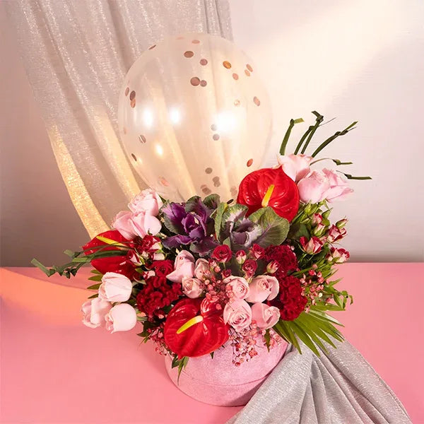 pink box with balloons red and baby roses celosia front view 2