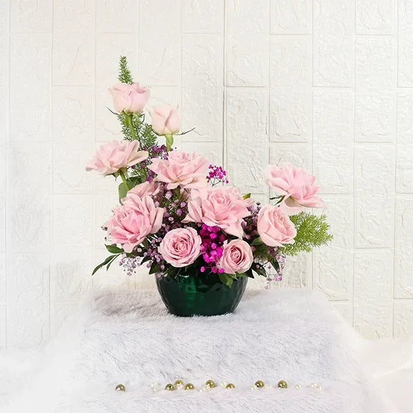 sweet roses and gypsophila in green metal pot close up view