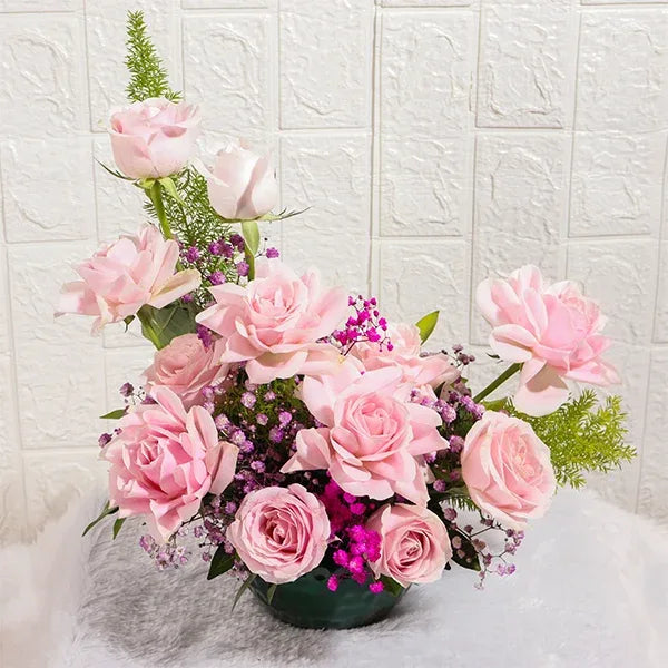 sweet roses and gypsophila in green metal pot front view