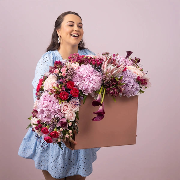 luxury box arrangement of carnation dark pink sweet avalanche roses close up view