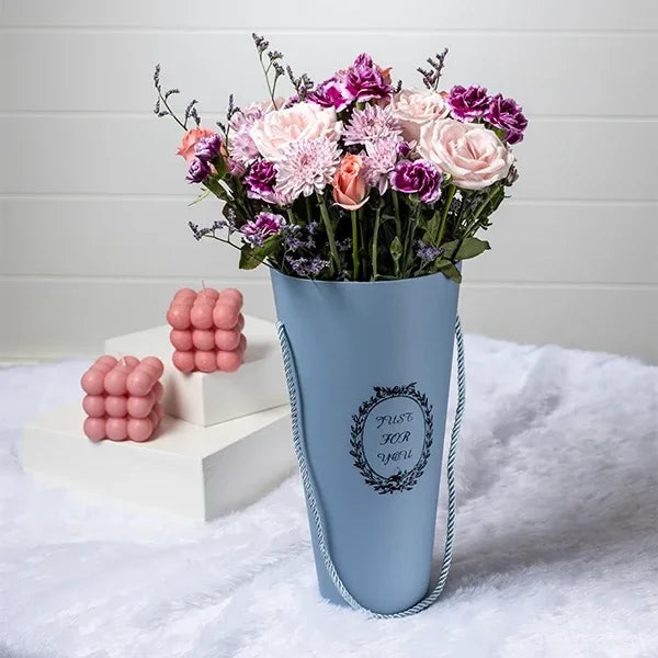 sweet avalanche baby pink roses with spray carnations in a cone shaped box front view