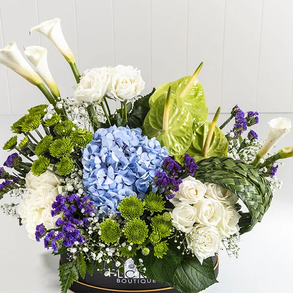 box arrangement of white calla lily white rose anthurium green closeup view