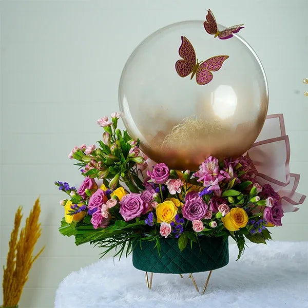green box with stand purple yellow roses spray carnations clear balloon front view