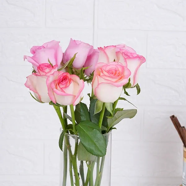 10 jumeila roses in long glass jar close up view