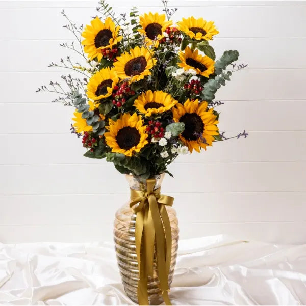 10 sunflower with red berry in golden glass vase front view