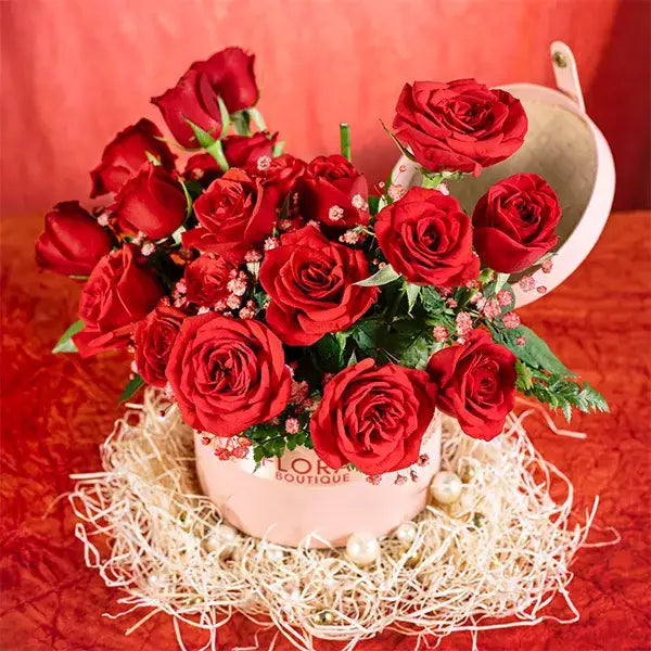 20 red roses and gypsophila in a pink box closeup view