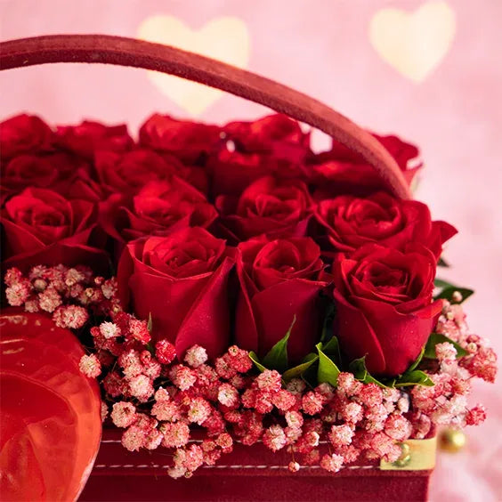 22 red roses with 4 anthurium in maroon square box closeup view