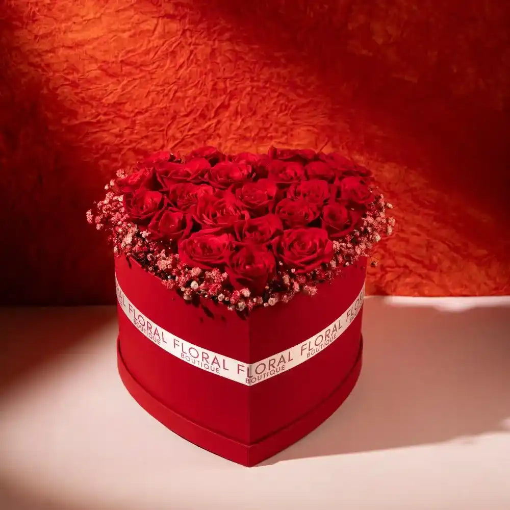 25 red roses in a red heart shaped box front view