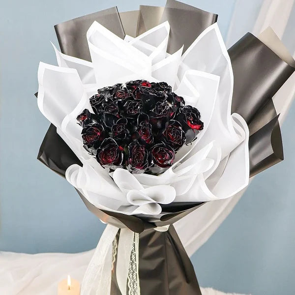 20 black rose bouquet wrapped in black and white paper closeup view