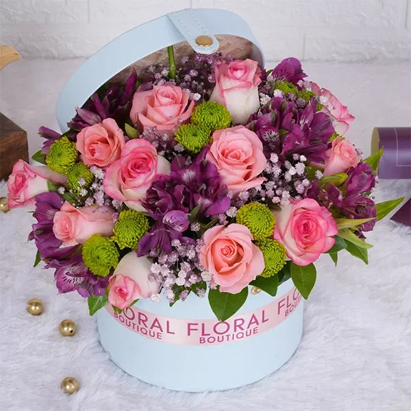 jumeila baby pink roses pink alstroemeria in a light blue gift box close up view