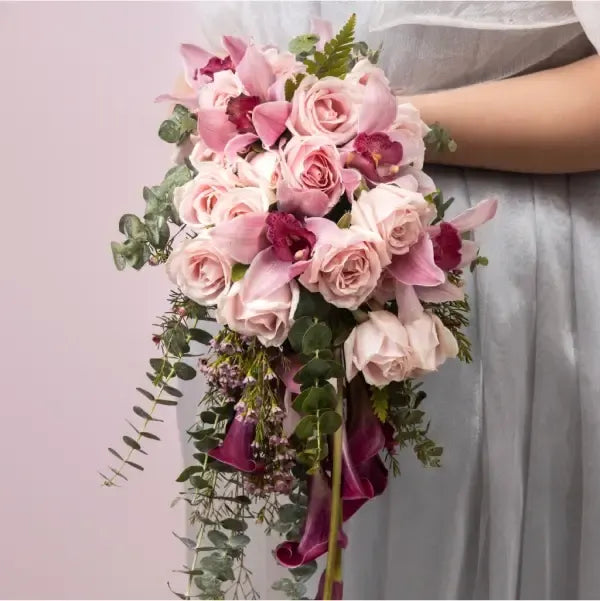 bridal bouquet of sweet avalanche rose with cala lilly close up view