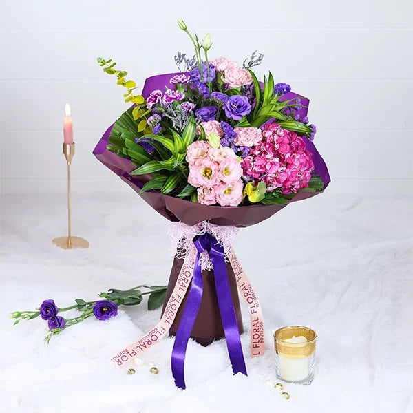hydrangea and carnation bouquet in purple wrapping paper front view 2