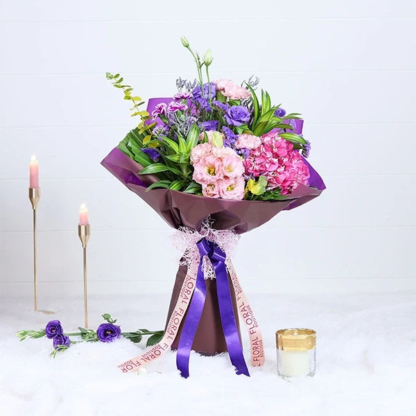 hydrangea and carnation bouquet in purple wrapping paper front view 3