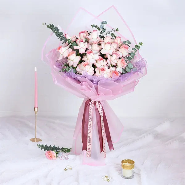 jumilia pink rose bouquet in pink wrapping paper front view 2