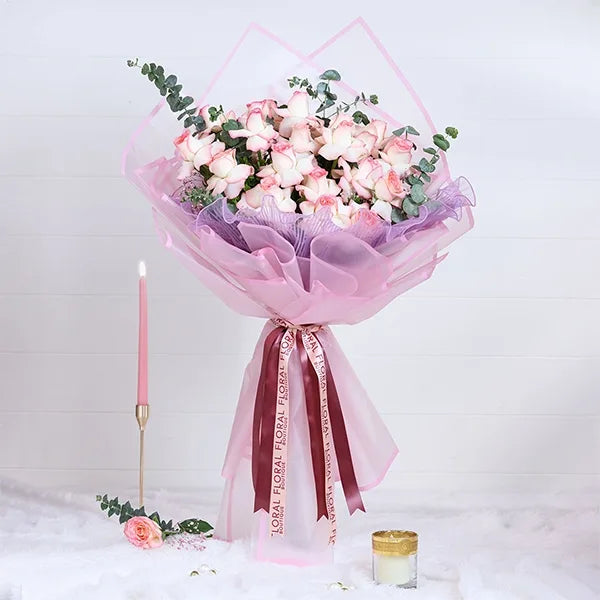 jumilia pink rose bouquet in pink wrapping paper front view